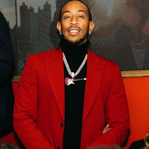 Ludacris is in a red suit in a picture.